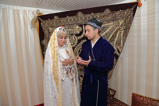 A bride and groom in traditional clothes