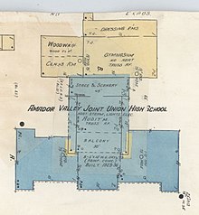 Architectural diagram of Amador Valley Joint Union High School. Image shows the auditorium on the bottom in blue, with additional rooms on the top in beige, including the woodworking floor, a classroom, a gymnasium, and dressing rooms.