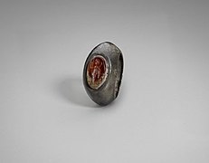 A silver ring set with a carnelian seal carved with a standing figure, circa 100–256 CE