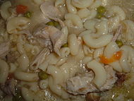 Homemade chicken soup with elbow macaroni, chicken pieces, carrots and celery