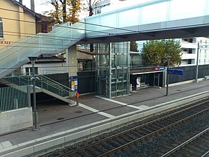 Enclosed elevator and walkway over double-track railway line