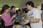 A volunteer displays a celestial globe for a young visitor, 2010