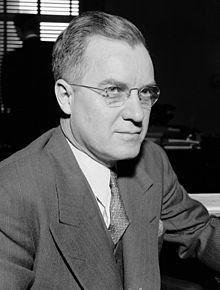 A man wearing a suit and glasses