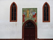 Wandbild über dem Südportal der Martinskirche in Basel, von 1922 zeigt der Heilige Martin.