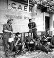 Stormont, Dundas and Glengarry Highlanders resting at Caen station, July 1944.