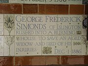 A tablet formed of five tiles of varying sizes, bordered by yellow and blue flowers in an art nouveau style