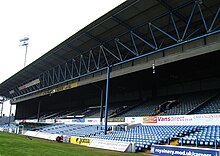 A football stand containing blue seats