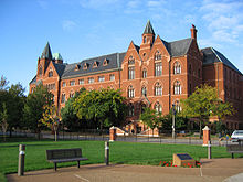 Photograph of DuBourg Hall behind a grass field