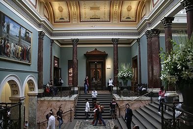 The Staircase Hall (1884–1887), designed by Sir John Taylor, in a photograph of 2007. To the left is Cimabue's Celebrated Madonna by Frederic, Lord Leighton (a loan from the Royal Collection since the 1990s).[71]