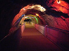 Crystal Valley, a tunnel with crystals in the wall and roof, illuminated by colourful lights.