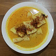 Laksan Palembang, fish cake similar to pempek served in rich coconut milk-based soup, and sprinkled with crispy fried shallot