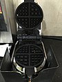 This is a waffle iron of the type commonly found at breakfast counters at motels/hotels in America. Customers pour in batter, close the waffle iron, and a timer begins, then sounds off when the waffle is ready.