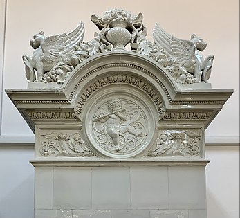 Upper part of a Neoclassical tiled stove, decorated with griffins, garlands (aka festoons), a medallion with a cerub (aka putto), cornucopias and foliage spirals, in the principals' house of the Central Girls' School, Bucharest, unknown designer, 1890