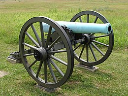 Photo shows an American Civil War era cannon with a pale green patina.