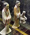 A female servant and a male advisor in Chinese shenyi, ceramic figurines from the Western Han period (202 BCE – 9 CE)