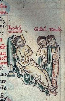 Part of a page of an illuminated manuscript showing Llywelyn the Great reclining to the left and his sons Gruffudd and Dafydd standing to the right.
