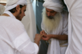 An initiate receiving a sacred gold ring called Shom Yawar Ziwa