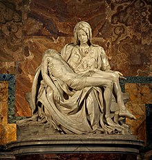 image of Michelangelo's famous sculpture the Pieta. Mary is seated looking at the body of her son draped across her lap.