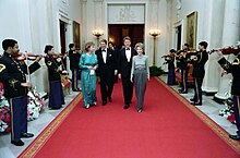 The Clintons and the Reagans walking a red carpet
