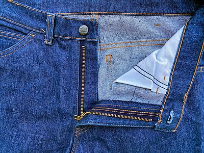 The button, rivets, zipper, buckles, and even the textile of clothing may contain metal allergens.