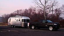 A modern Airstream, 2016 Flying Cloud 23D travel trailer shown with tow vehicle, GMC Sierra