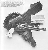 Caption reads: Burnham's sidearm in the Tonto Basin, the Geronimo Campaign, Rhodesia, East Africa, and Mexico was this Remington Model 1875, serial no. 11, in .44–40 caliber. Holster and Rhodesian bandoleer are original; the .44–40 cartridge box bears the stamp of the Rhodesian government. Pistol grips are hippo ivory.