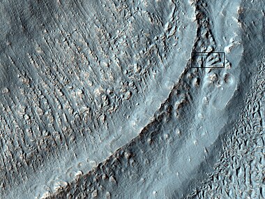 Close-up of the area in the box in the previous image. This may be called by some the terminal moraine of a glacier. For scale, the box shows the approximate size of a football field. Image taken with HiRISE under the HiWish program. Location is Hellas quadrangle.
