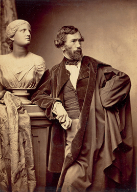 The sculptor François Jouffroy in 1865 wearing the men's fashion of the day, holding his gloves in his hand to show that he could afford them, but did not need them.