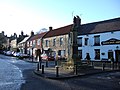 The market cross stands at the junction of the three main roads in the village.