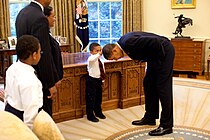 Hair Like Mine (2009) depicts Obama bending down to allow a child to touch his hair in the Oval Office