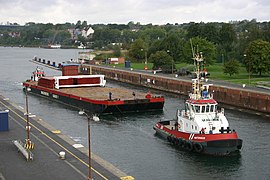 Dutch tugboat Watergeus towing a barge in the locks at Kiel-Holtenau