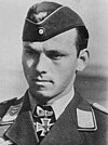 A portray of a man wearing a military uniform, side cap and neck order in shape of an Iron Cross.