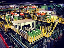 Inside the main processing building, with a network of machines, conveyor belts, and walkways for employees to move around