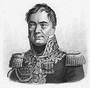 Black and white print shows a clean-shaven man with a cleft chin and widely spaced eyes. He wears a dark French military uniform of a general of the Napoleonic era, with a high collar, epaulettes and lots of lace on the collar and front.