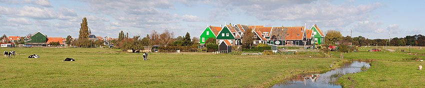Marken is a peninsula in the IJsselmeer, the Netherlands, located in the municipality Waterland in the province North Holland. It is a former island, which nowadays is connected to the mainland by a causeway. Visible in this panaroma are the community of Grote Werf with the village of Marken in the background.