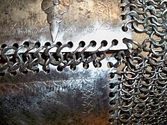 Close up of Mughal riveted mail and plate coat zirah Bagtar, 17th century, alternating rows of solid rings and round riveted rings.