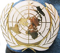 Cap badge of United Nations peacekeeping forces on a blue beret.