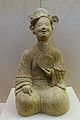 A Chinese ceramic statue of a woman holding a bronze mirror, Eastern Han period (25-220 AD), Sichuan Museum, Chengdu