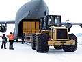 A Caterpillar 950G unloads cargo from a C-17 at McMurdo Station (Antarctica)