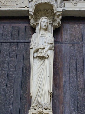 Saint Anne holding the infant Virgin Mary on the trumeau of the central portal of the north transept