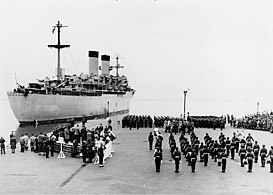 In 1951, during the Korean War, a troopship, the USS General George M. Randall (AP-115), departs Yokohama, repatriating war dead to the U.S.