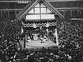 Inside of the arena with crowded seats during a ceremony performed by wrestlers