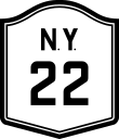 A sign with the number 22 on it, similar to the one at the top of the article and in other pictures but with an additional black border, the letters "NY" above the numbers, and a different typeface for the numbers themselves