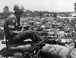Black-and-white photo of a soldier sitting outdoors