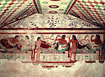 Wall painting depicting people banqueting and two leopards