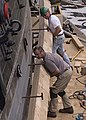 Draw-bore pins (hook pins) are the metal pins sticking out of the plank above the plank being added to the USS Constitution during restoration.