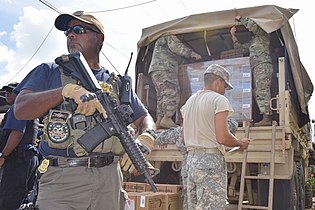Armed petty officer guarding relief for residents of Canóvanas on Oct. 17, 2017