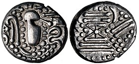 A Chaulukya-Paramara coin, circa 950-1050 CE. Stylized rendition of Chavda dynasty coins: Indo-Sassanian style bust right; pellets and ornaments around / Stylised fire altar; pellets around.[1] of Chaulukya