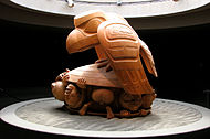 The Raven and the First Men, UBC Museum of Anthropology. It depicts part of a Haida creation myth. The Raven represents the Trickster figure common to many mythologies.