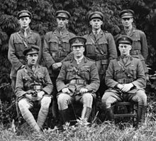 a black and white group photograph of six men in uniform